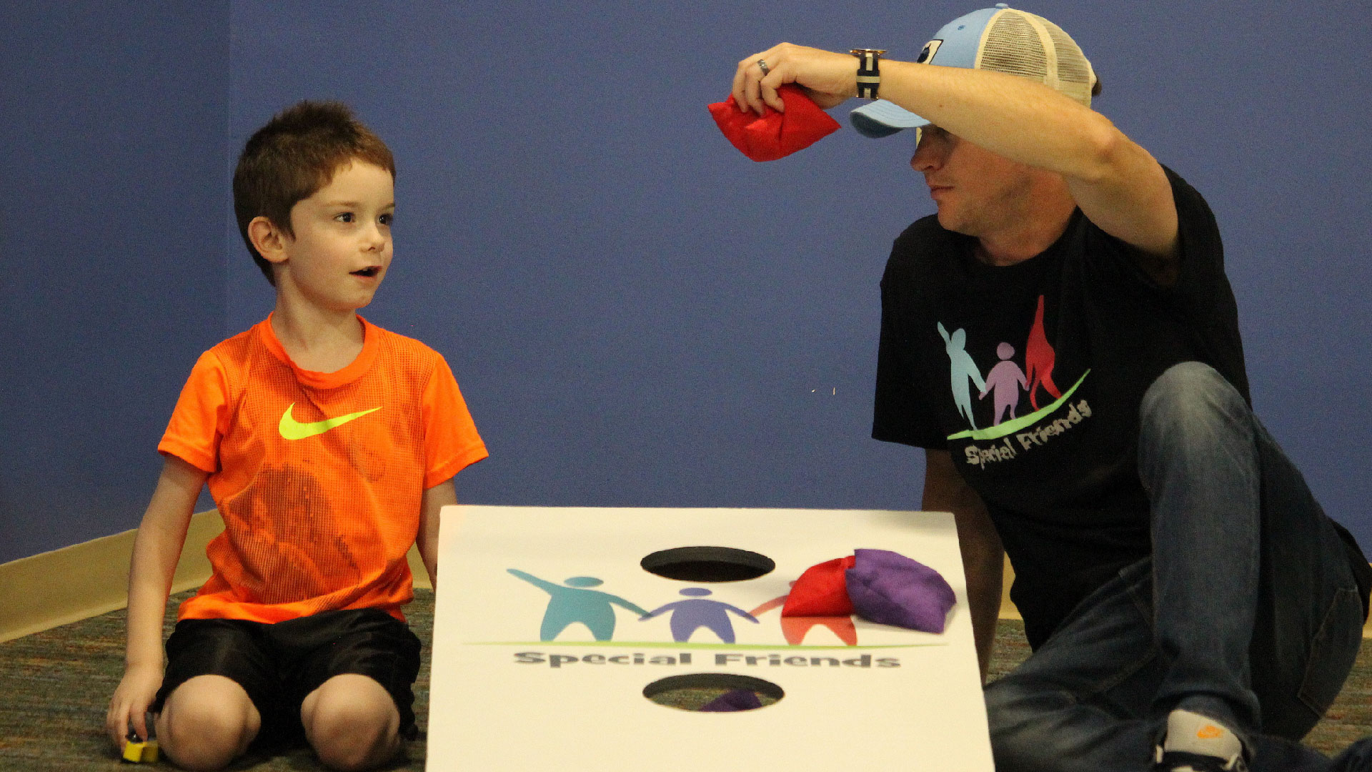 A special needs child and a Brookwood Church Special Friends Volunteer playing games